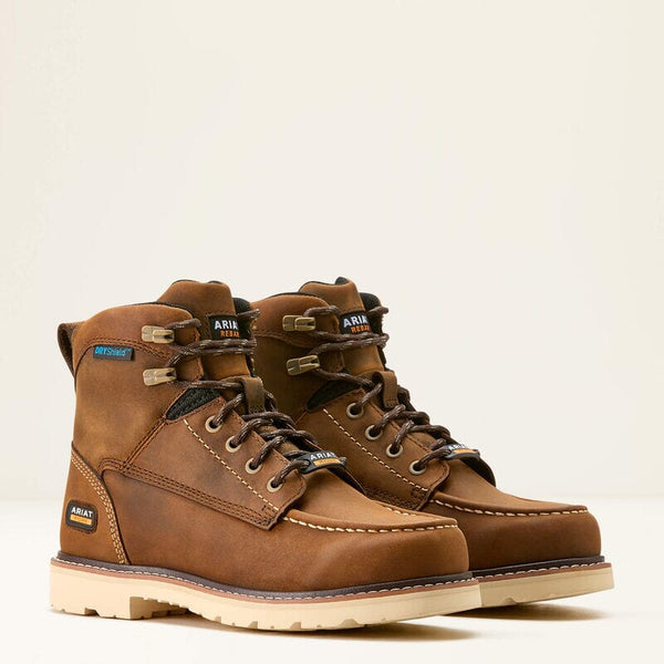 A pair of brown, waterproof work boots with a round moc toe and a lightly padded collar, featuring a label with the brand name 'Ariat' on the upper and heel.