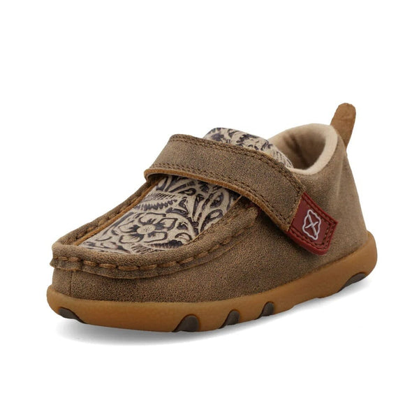 Brown children's moccasin shoe with a patterned top and strap across the tongue