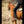 Load image into Gallery viewer, woman in western clothes and brown cowgirl hat riding brown horse in dirt outside