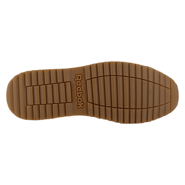 Tan shoe sole with tread pattern and stamped Reebok logo in center on a white background