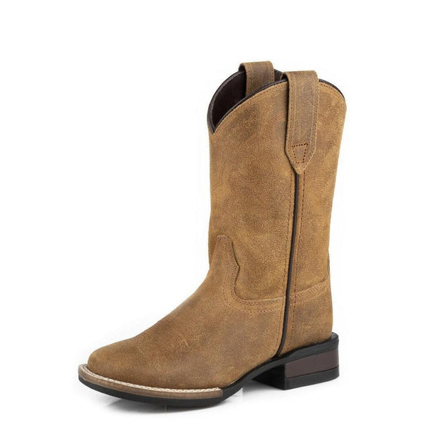 Left front angled view of tan-colored, square-toe, Western-style boot made of oiled suede leather with a low heel and pull tab.