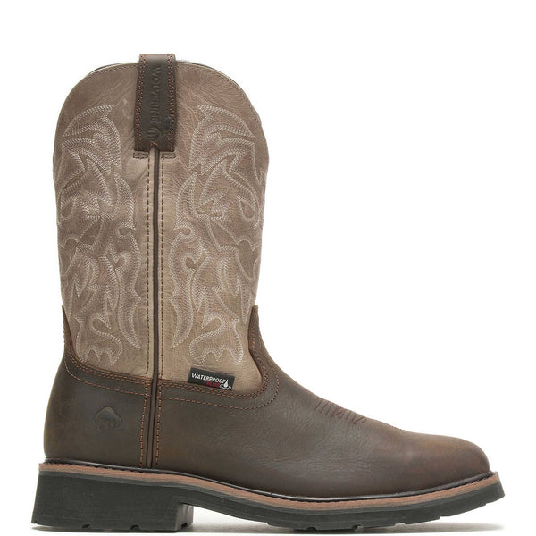 Right side view of brown cowboy work boot with intricate stitching on shaft on a white background