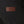 Load image into Gallery viewer, Detailed close view of black denim jeans back pocket with sewn on Wrangler patch
