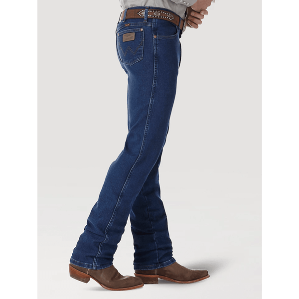 side view of man wearing blue jeans with brown boots and belt