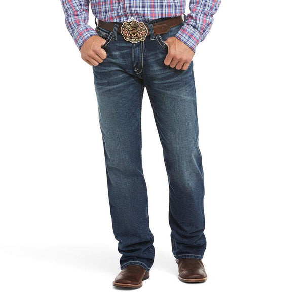 man wearing blue jeans and a plaid shirt