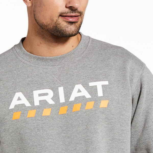 chest view of Man wearing grey sweatshirt with Ariat written on the front and a yellow dotted line pattern underneath 