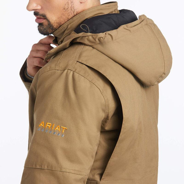 shoulder view of man wearing a brown insulated coat and dark jeans