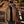 Load image into Gallery viewer, man wearing brown insulated jacked and black hat walking in front of construction equipment