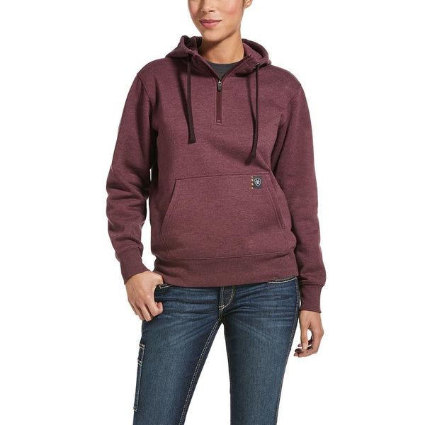 woman wearing maroon hoodie with kangaroo pocket and blue jeans