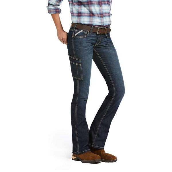 woman from chest down wearing red and blue plaid and dark blue jeans