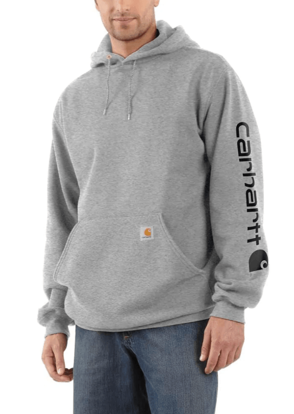 man wearing light grey hoodie with carhartt logo vertically on sleeve