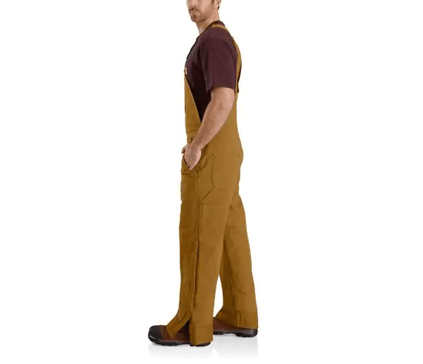alternative side view of man wearing brown bib insulated overalls