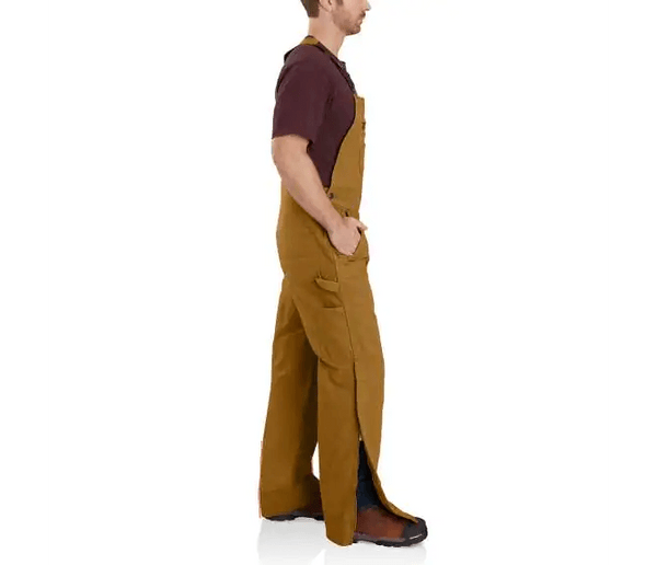 side view of man wearing brown bib insulated overalls