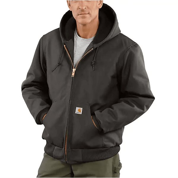 man wearing dark grey heavy jacket with hood and hands in pockets