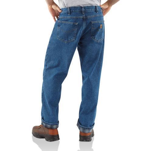 back view of man wearing blue jeans with brown boots