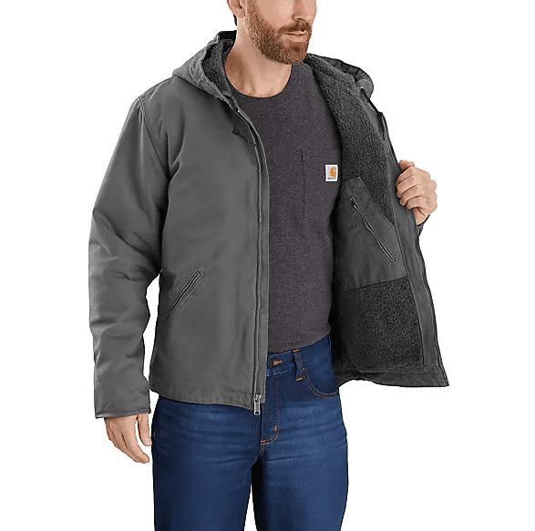 man showing the fleece lined interior and pocket of grey jacket with hood