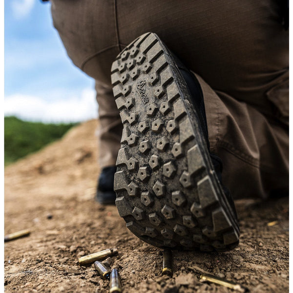 black sole of boot on my kneeling in dirt