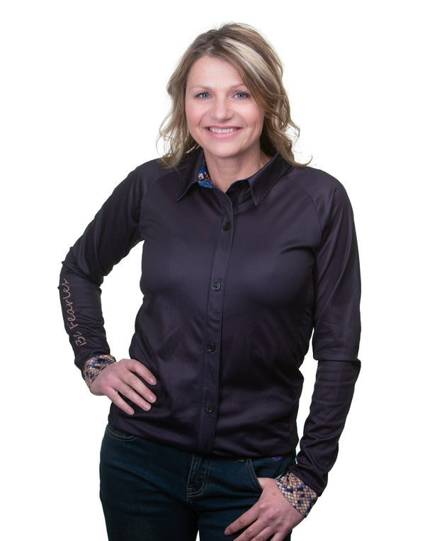 woman wearing black long sleeve button up shirt with pattern print on sleeve cuffs.