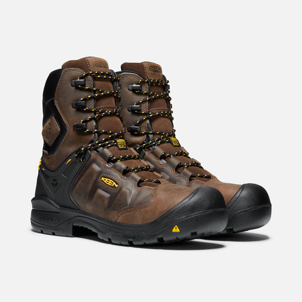 brown hightop boots with yellow and black laces, black toe guard and sole, black eyelets