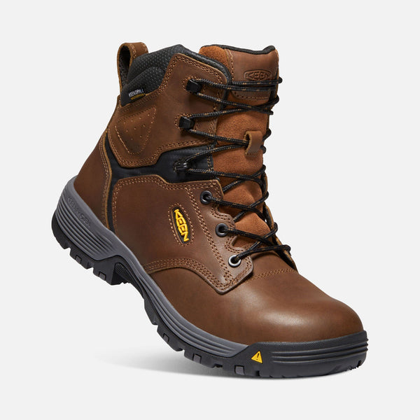 angled view of tan hightop boot with black laces and eyelets, grey and black sole