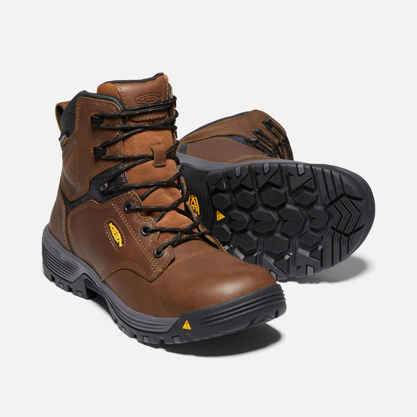 tan hightop boots with black laces and eyelets, grey and black sole