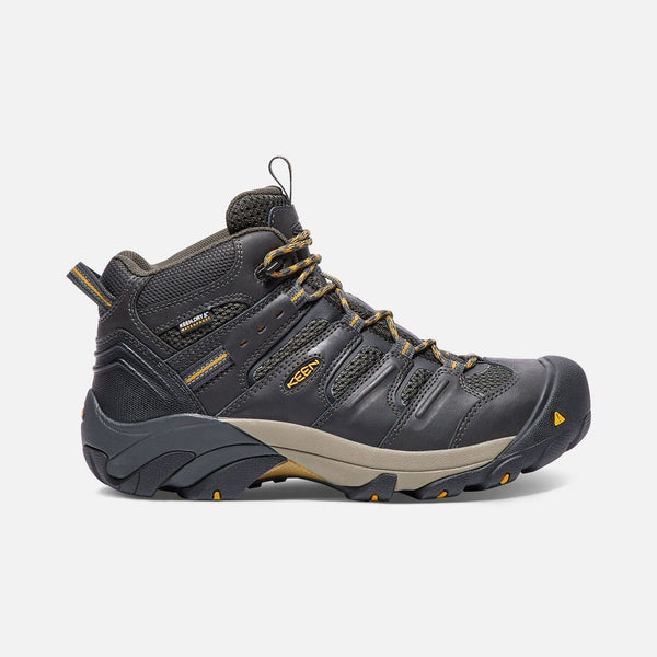 black boot with black and khaki sole and green and khaki laces