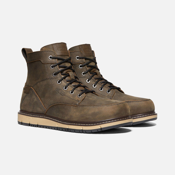 two brown hightop shoes with dark laces and tan sole