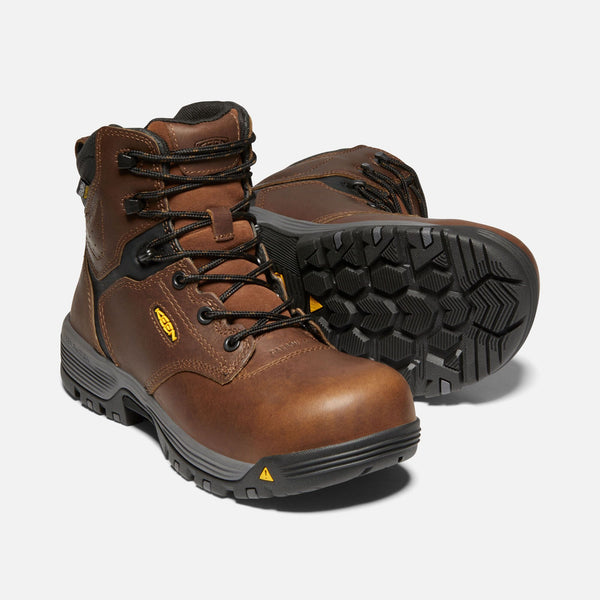 brown boots with black and grey sole, black laces and eyelets