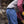 Load image into Gallery viewer, man wearing blue denim boot cut jeans and brown vest