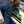 Load image into Gallery viewer, man working and wearing navy blue denim boot cut jeans with leg pockets