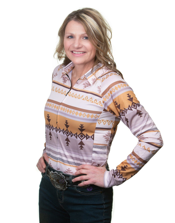 woman with hands on her hips, wearing cream and brown patterned long sleeve button up shirt
