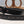 Load image into Gallery viewer, black leather belt with stamped design on table
