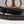 Load image into Gallery viewer, black leather belt with stamped design on table