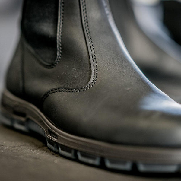 up close of mid-rise black pull on boot with red pull strings