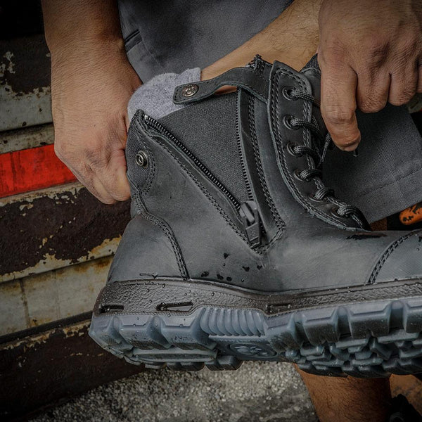 zipper on black work boot with black string and black eyelets