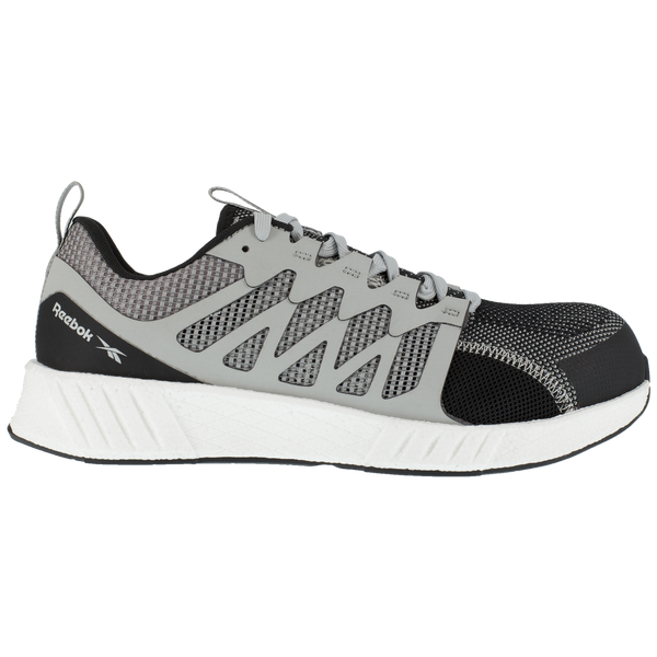side of shoe with black toe and grey foot with vent holes and white sole