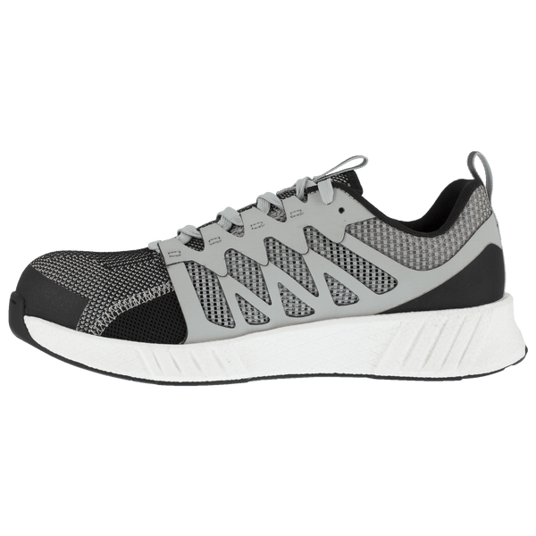 side view of shoe with black toe and grey foot with vent holes and white sole