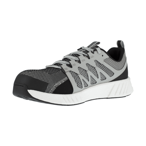 angled view of shoe with black toe and grey foot with vent holes and white sole
