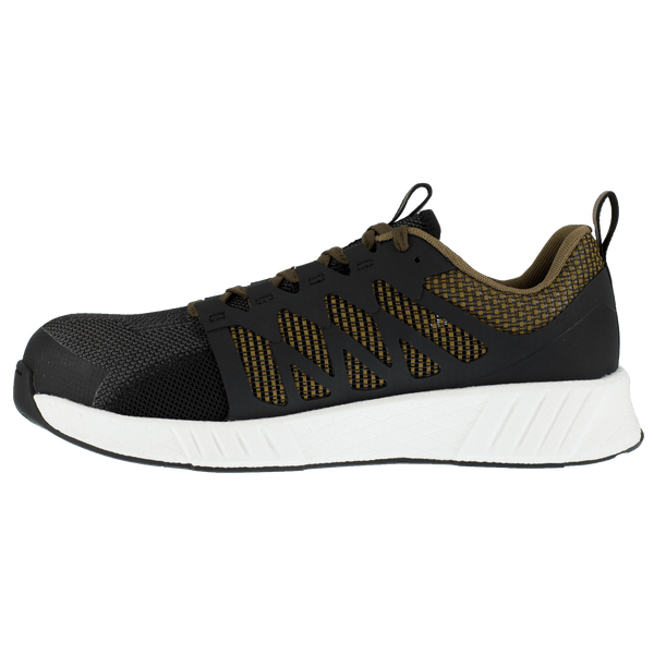 side view of black shoe with green underneath black pattern on foot and green laces