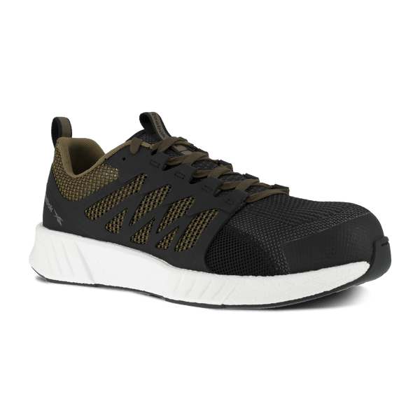 black shoe with green underneath black pattern on foot and green laces