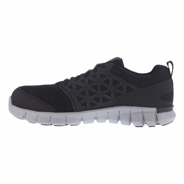 side of black shoe with grey sole. triangle pattern on side. reebok on heel