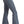 Load image into Gallery viewer, side view of woman wearing medium blue bell bottom jeans, with button details on waistband and tan point toe boots, with hand in back pocket
