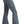 Load image into Gallery viewer, side view of woman wearing medium blue bell bottom jeans, with button details on waistband and tan point toe boots, with hand in back pocket