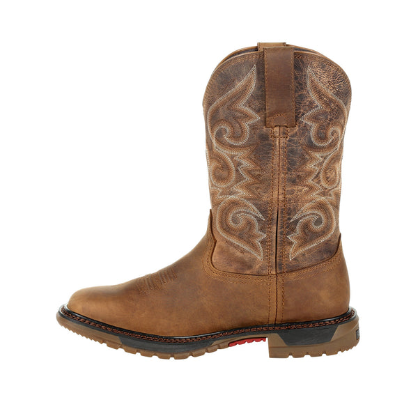 side of cowgirl boot with distressed shaft and white and brown embroidery