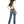 Load image into Gallery viewer, back of brunette woman wearing medium blue denim jeans with hand in back pocket, cream long sleeve top, and brown boots, belt, and cowgirl hat