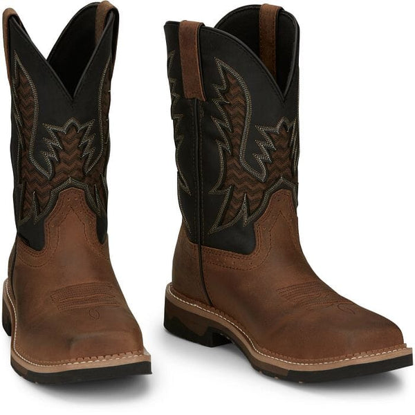 pair of mens western square toe work boots with brown vamp and black shaft with brown and black vent and white and tan embroidery