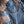 Load image into Gallery viewer, blue jeans with feather embroidered on back pocket and leopard print on hem, folded on top of leopard and desert print collared shirt.