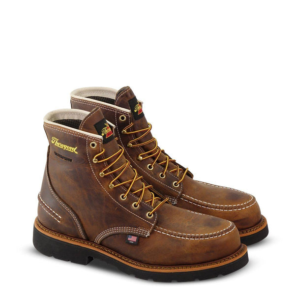 high top brown boot with yellow laces, black sole, and yellow logo on upper shaft