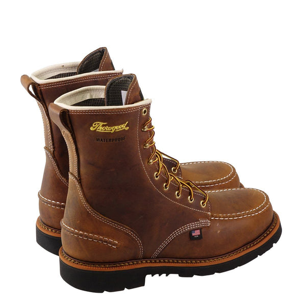 pair of mens brown logger boot with black soles white stitching and yellow thorogood logo, side back view