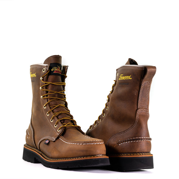 pair of mens brown logger boot with black soles white stitching and yellow thorogood logo, alternated view